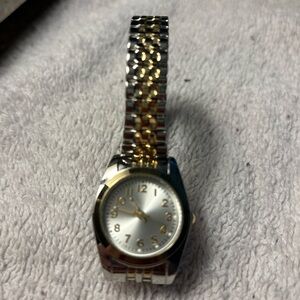Stainless steel and gold tone accent stretch watch. Face is 1” x 1”.